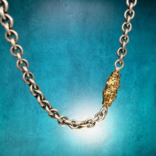 Load image into Gallery viewer, Gold chain with a clasp on a textured blue background